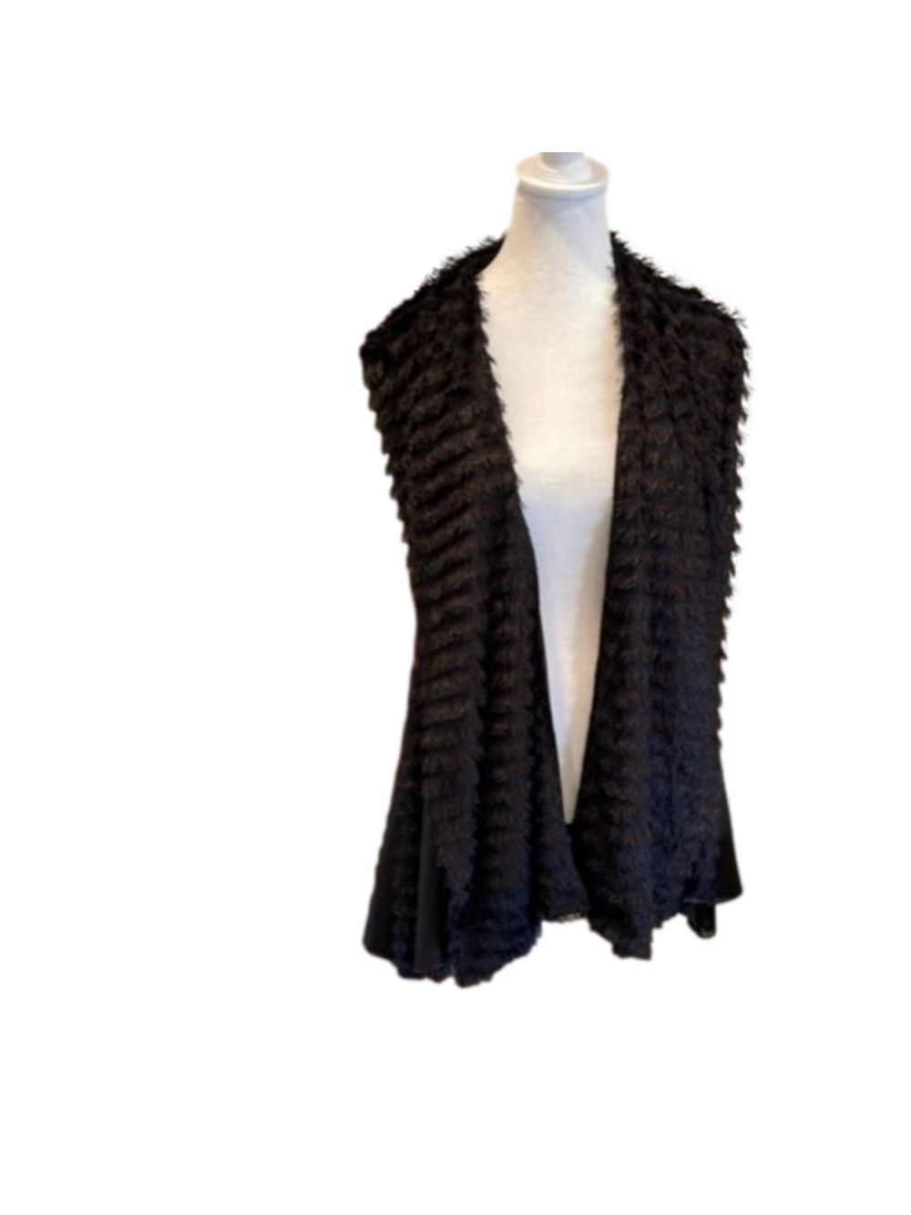 Small/medium but fits larger. Fabulous zipper detail  and fringe.